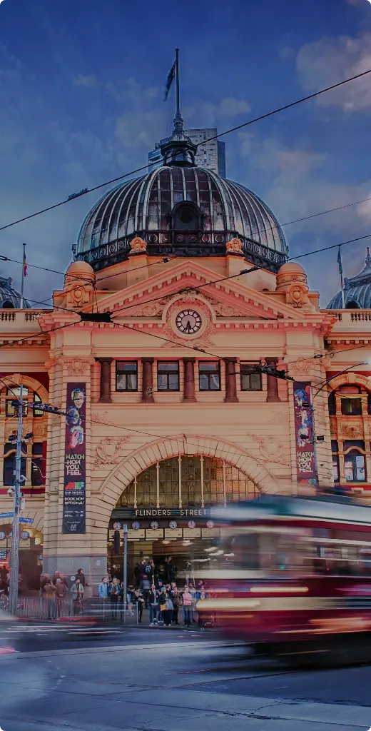 Iconic Flinders Street Station facade in Melbourne, Australia, with motion blur from passing trams