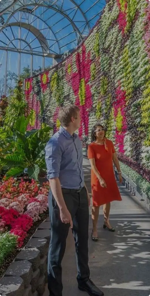 Couple walking through the Flower Dome at the Royal Botanic Garden Sydney with vibrant floral displays